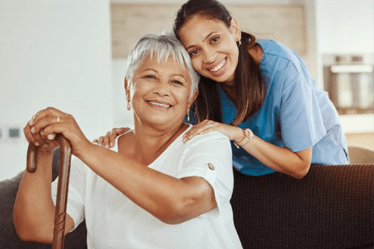 A woman and an older person smiling for the camera.