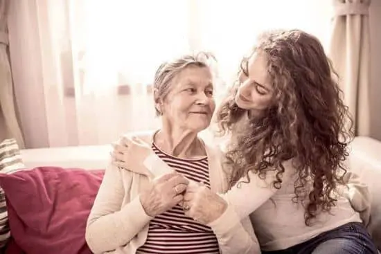 A woman and an older lady smiling for the camera.