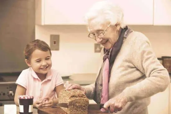 A young girl and an old woman are smiling.